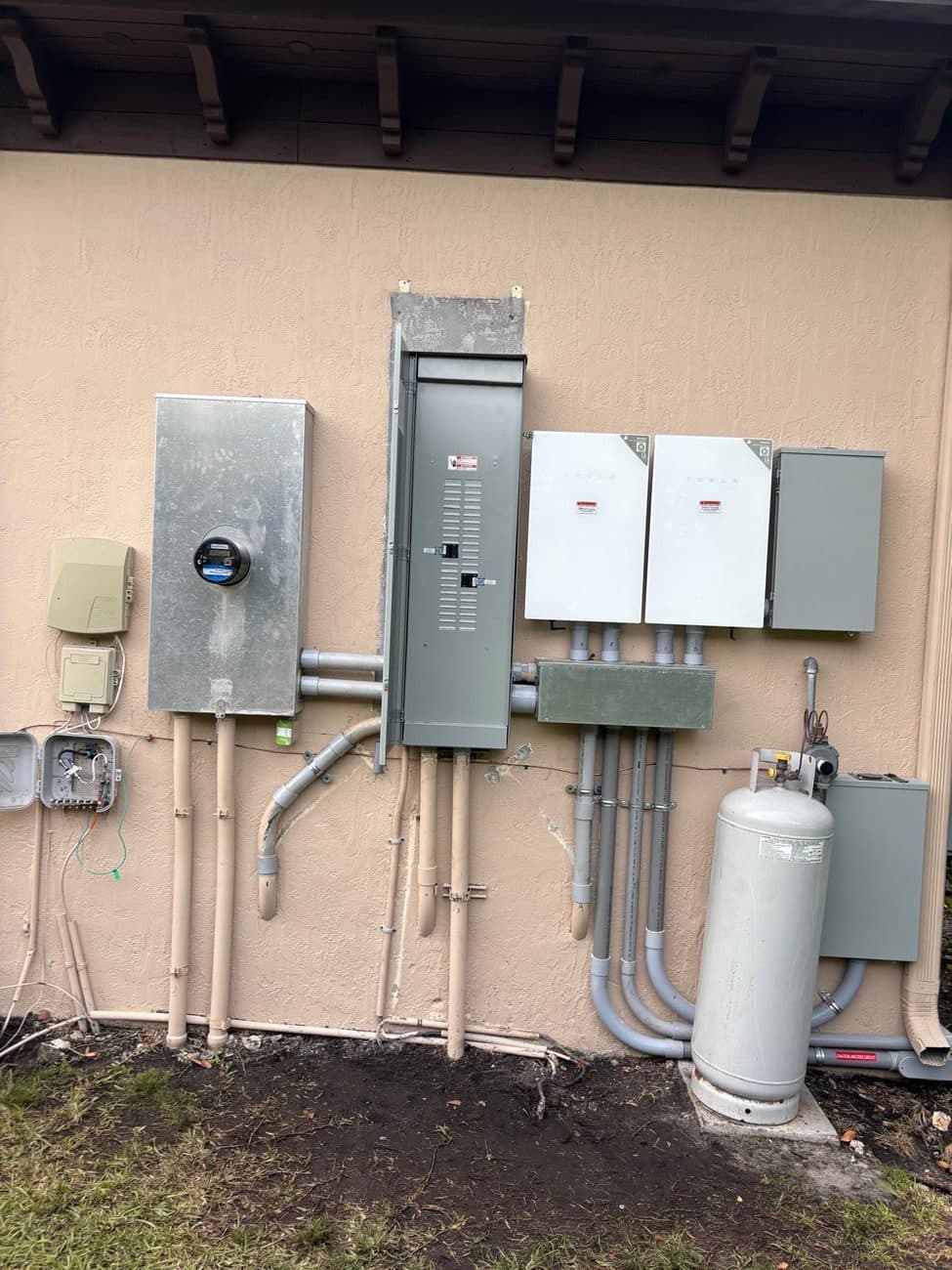A completed Ghost Crown Electric residential service: new meter can, main panel, disconnects, and battery backup